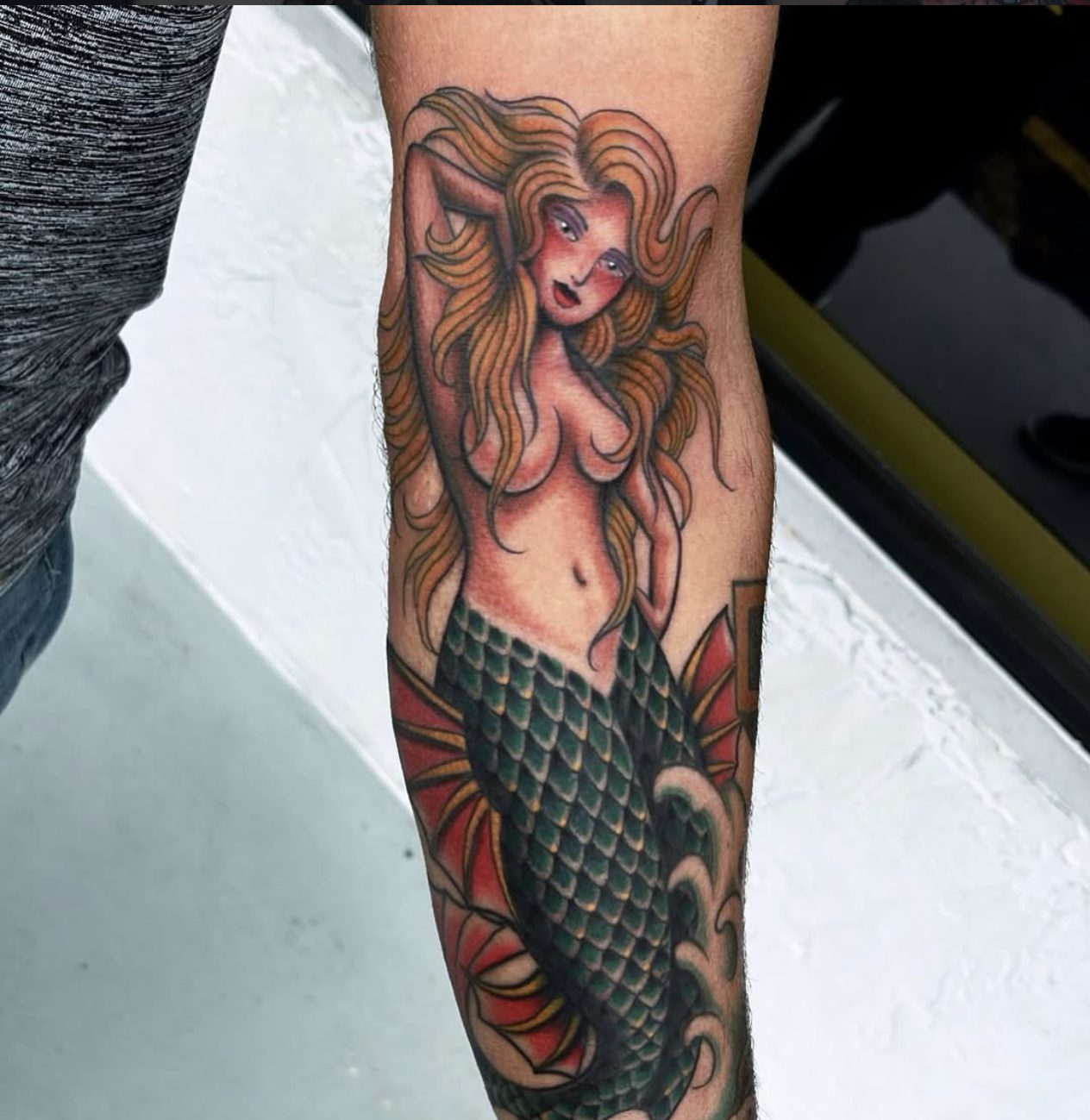 Traditional mermaid forearm tattoo in color by Danny Mac